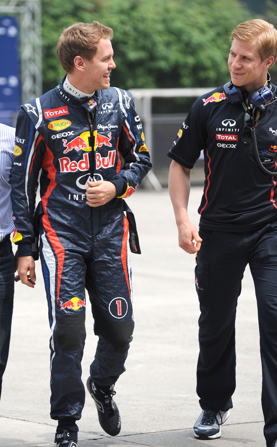 Sebastian Vettel jokes with his physio in the paddock