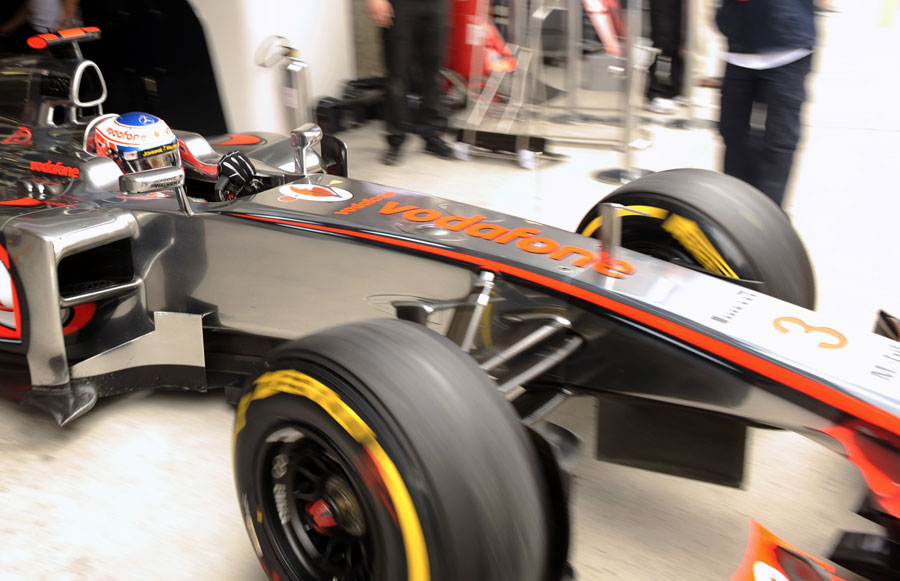 Jenson Button leaves the McLaren garage
