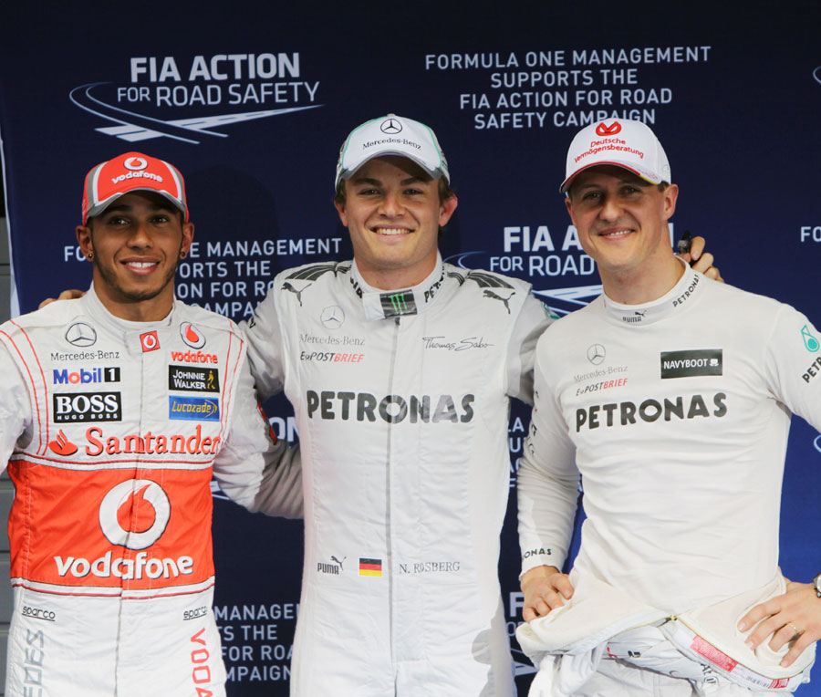 Nico Rosberg celebrates his maiden pole position with Lewis Hamilton and Michael Schumacher
