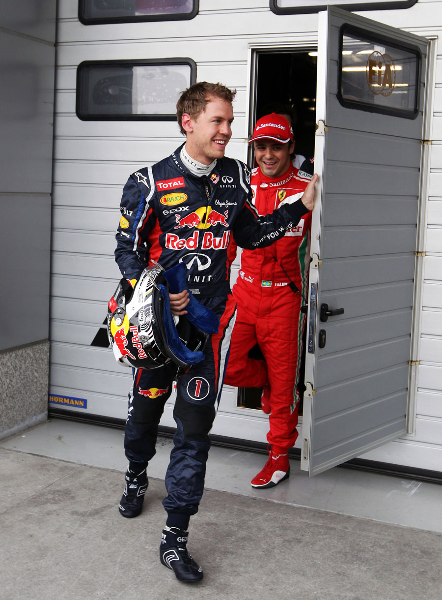 Sebastian Vettel and Felipe Massa leave the weigh-room after being eliminated in Q2
