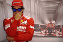 Fernando Alonso watches on nervously from the back of the Ferrari garage