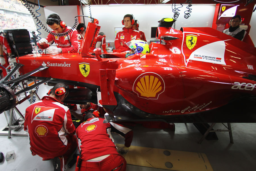 Ferrari mechanics work on Felipe Massa's car