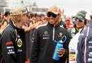 Kimi Raikkonen and Lewis Hamilton share a joke on the grid