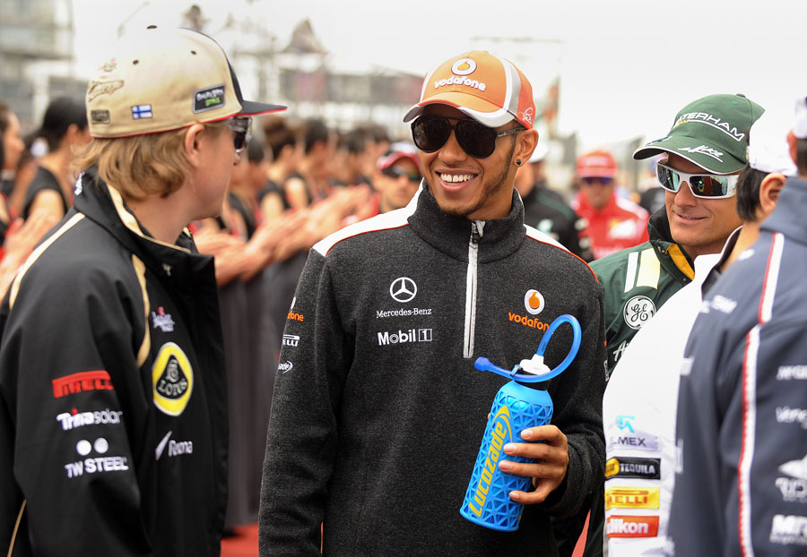 Kimi Raikkonen and Lewis Hamilton share a joke on the grid