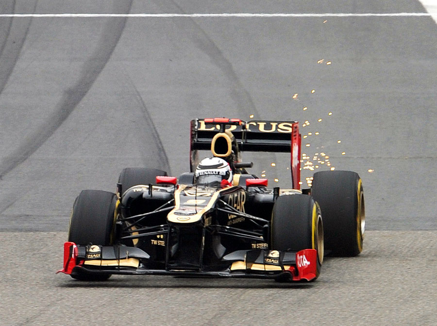 Sparks fly from the rear of Kimi Raikkonen's Lotus