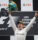 Nico Rosberg celebrates his maiden victory on the podium