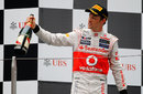 Jenson Button salutes his team on the podium