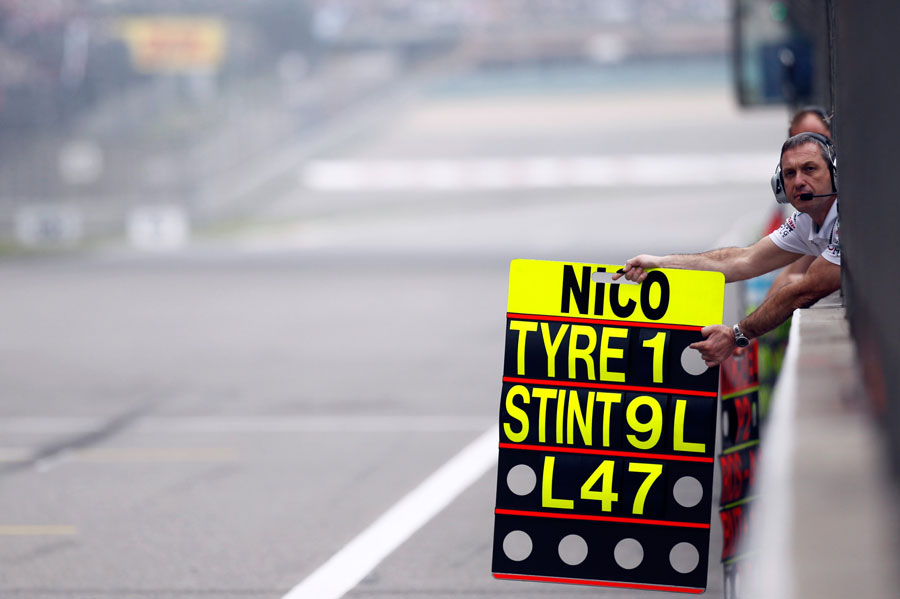 A Mercedes mechanic holds out Nico Rosberg's pit board