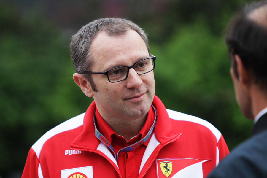 Stefano Domenicali listens intently in the paddock