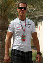 Michael Schumacher walks through the paddock