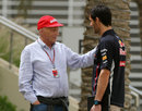 Niki Lauda chats to Mark Webber in the paddock