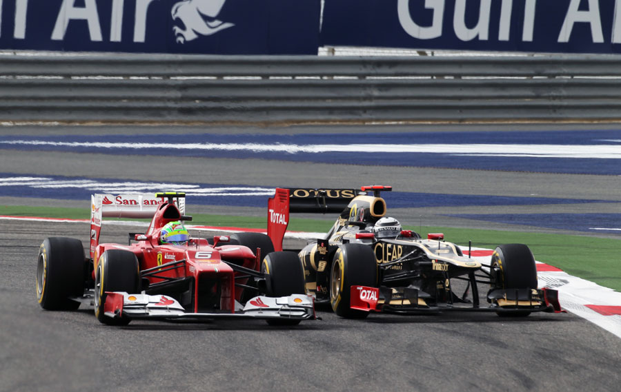 Kimi Raikkonen looks to the outside of Felipe Massa as he tries to find a way past