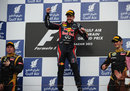 Sebastian Vettel celebrates on the podium alongside Kimi Raikkonen and Romain Grosjean