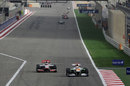 Jenson Button takes a look down the inside of Paul di Resta in to turn one