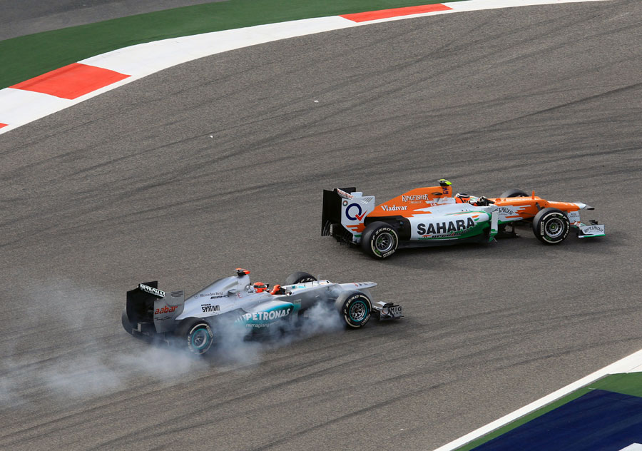 Michael Schumacher locks a wheel while attempting to pass Nico Hulkenberg