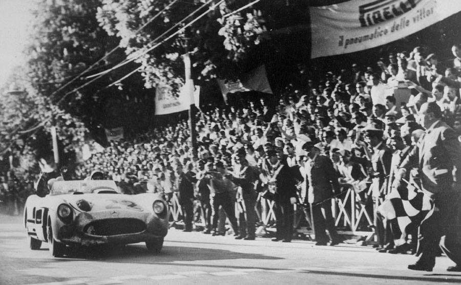 Stirling Moss crosses the line in Brescia to take victory at the Mille Miglia