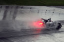 Spray flies from the rear of Valtteri Bottas's Williams