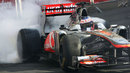 Jenson Button burns rubber during a demonstration run in Budapest