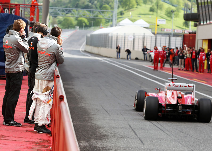 McLaren test drivers Gary Paffett and Oliver Turvey watch Felipe Massa leave the pits