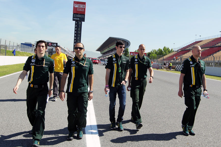 Alexander Rossi walks the track with his Caterham engineers ahead of his FP1 debut this weekend