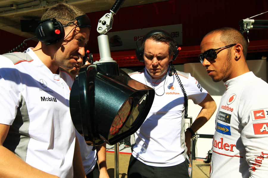 Lewis Hamilton inspects the new McLaren pit stop light system