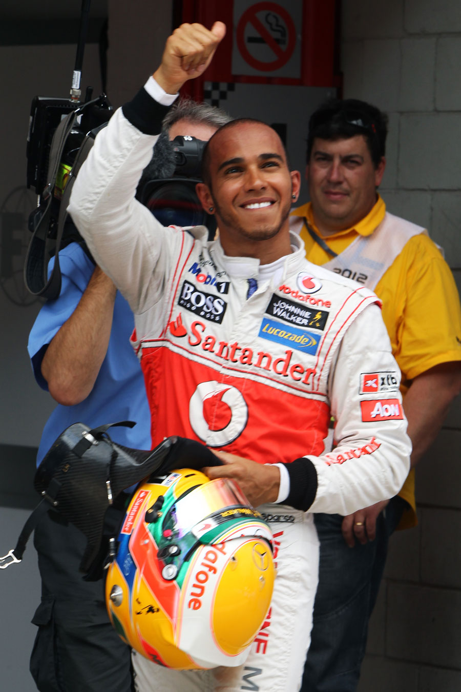 Lewis Hamilton waves to the fans after taking pole position