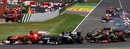 Fernando Alonso and Pastor Maldonado side by side into the first bend