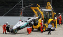 Michael Schumacher's Mercedes is hauled away after his collision