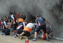 Mechanics tackle the blaze in the Williams garage