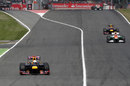 Sebastian Vettel exits the pit lane in front of Nico Hulkenberg and Mark Webber