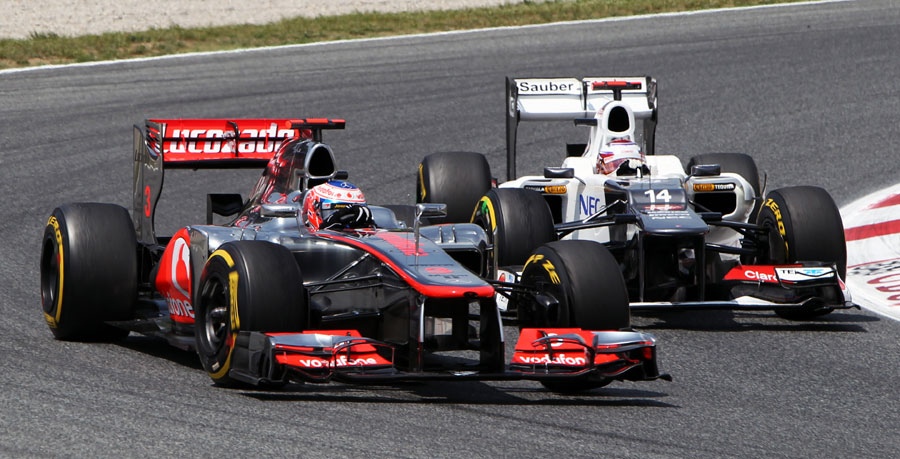 Kamui Kobayashi looks for a way up the inside of Jenson Button