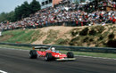 Jody Scheckter speeds past the thousands of fans on his way to victory