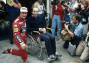 Nigel Mansell poses for a photo with Frank Williams on his return to the paddock following the accident that paralysed him from the chest down