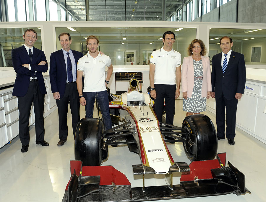 HRT officials, drivers Pedro de la Rosa and Dani Clos and the mayoress of Madrid pose for a photo in the team's new factory