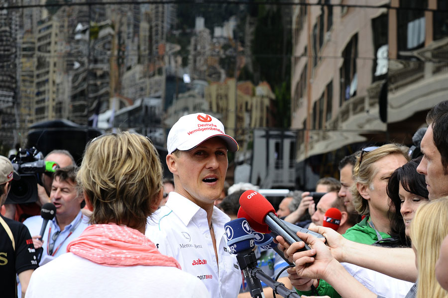 Michael Schumacher speaks to the press in the paddock