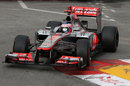 Jenson Button rides the kerbs at the swimming pool chicane on his way to the quickest time in FP2