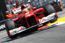 Fernando Alonso launches his Ferrari over the kerbs