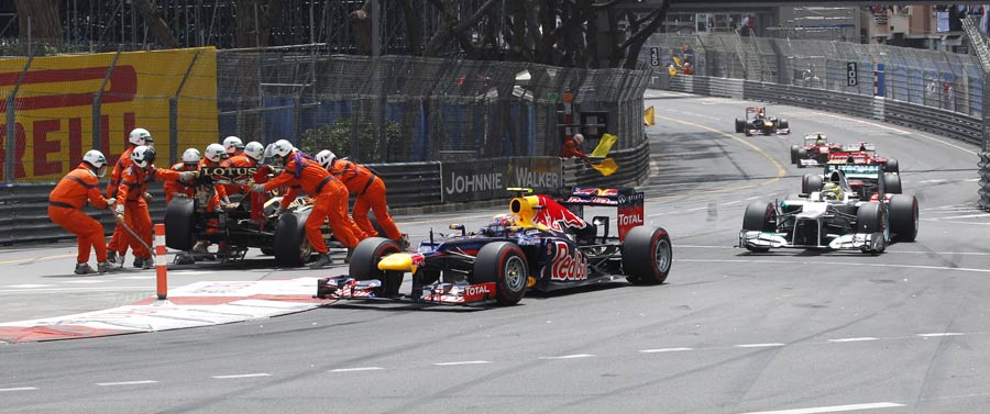Mark Webber passes Romain Grosjean at the start