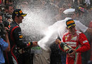 Mark Webber sprays Fernando Alonso with champagne after winning in Monaco
