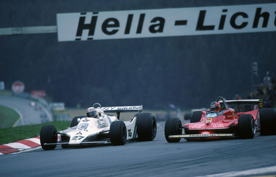 Alan Jones dives down the inside of Gilles Villeneuve to take the lead