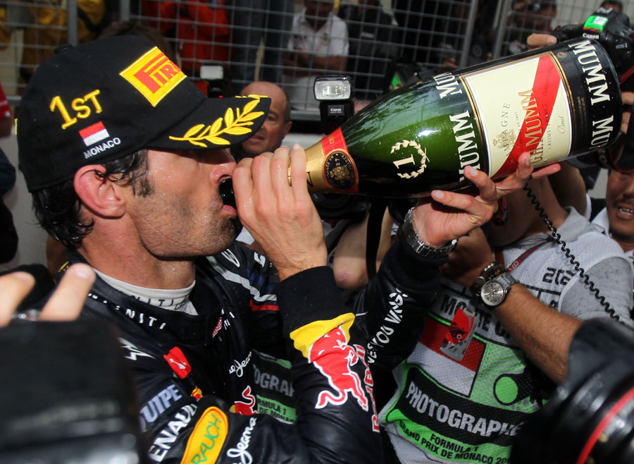 Mark Webber takes a swig of champagne after winning in Monaco