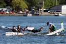 Williams and Lotus crews race boats on the lake