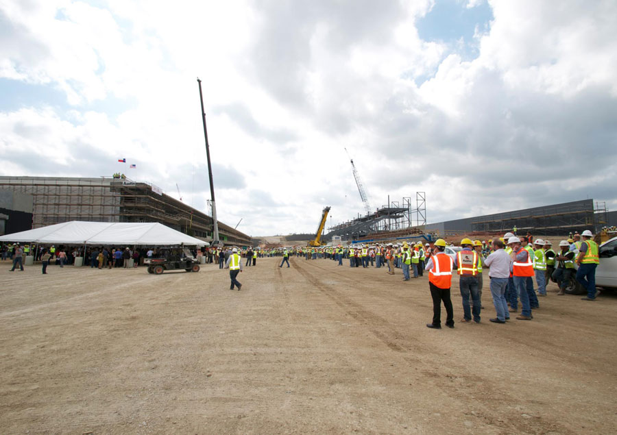 Workers congregate for a topping off ceremony at the Circuit of the Americas