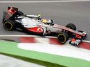 Lewis Hamilton attacks the kerbs in his McLaren