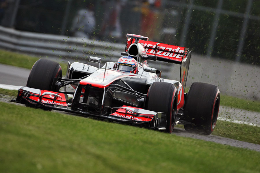 Jenson Button runs across the grass late in FP2