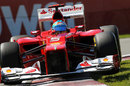 Fernando Alonso attacks the kerbs in his Ferrari