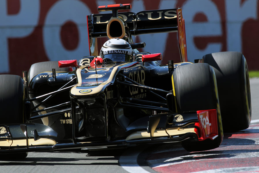 Kimi Raikkonen rides the kerbs in his Lotus
