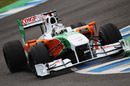 Adrian Sutil rides the kerbing in his Force India