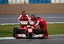 Ferrari mechanics run to the aid of Felipe Massa as he stops at the pit lane entrance