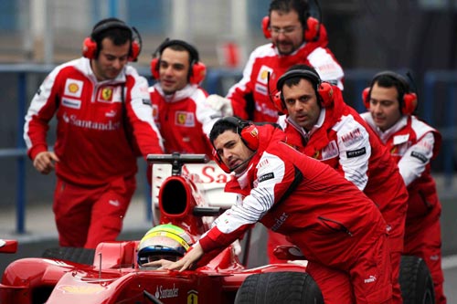 Felipe Massa is pushed back to the pits